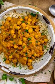 Chana Masala — golden chickpea curry served over basmati rice in a ceramic bowl
