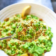 Herb Pilaf — vibrant green herb and grain dish with fresh peas and a wedge of lemon