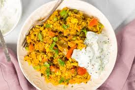 Masala Khichdi — comforting spiced rice and vegetable dish topped with cooling yogurt