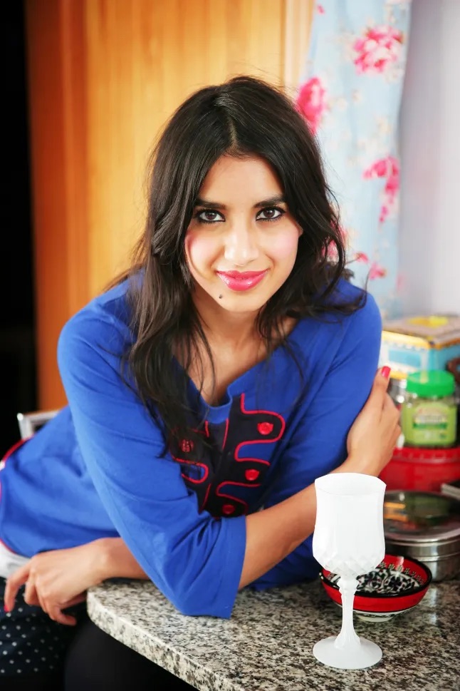 Chef Jatinder, head chef and founder of Kaur's Kitchen, smiling in her kitchen
